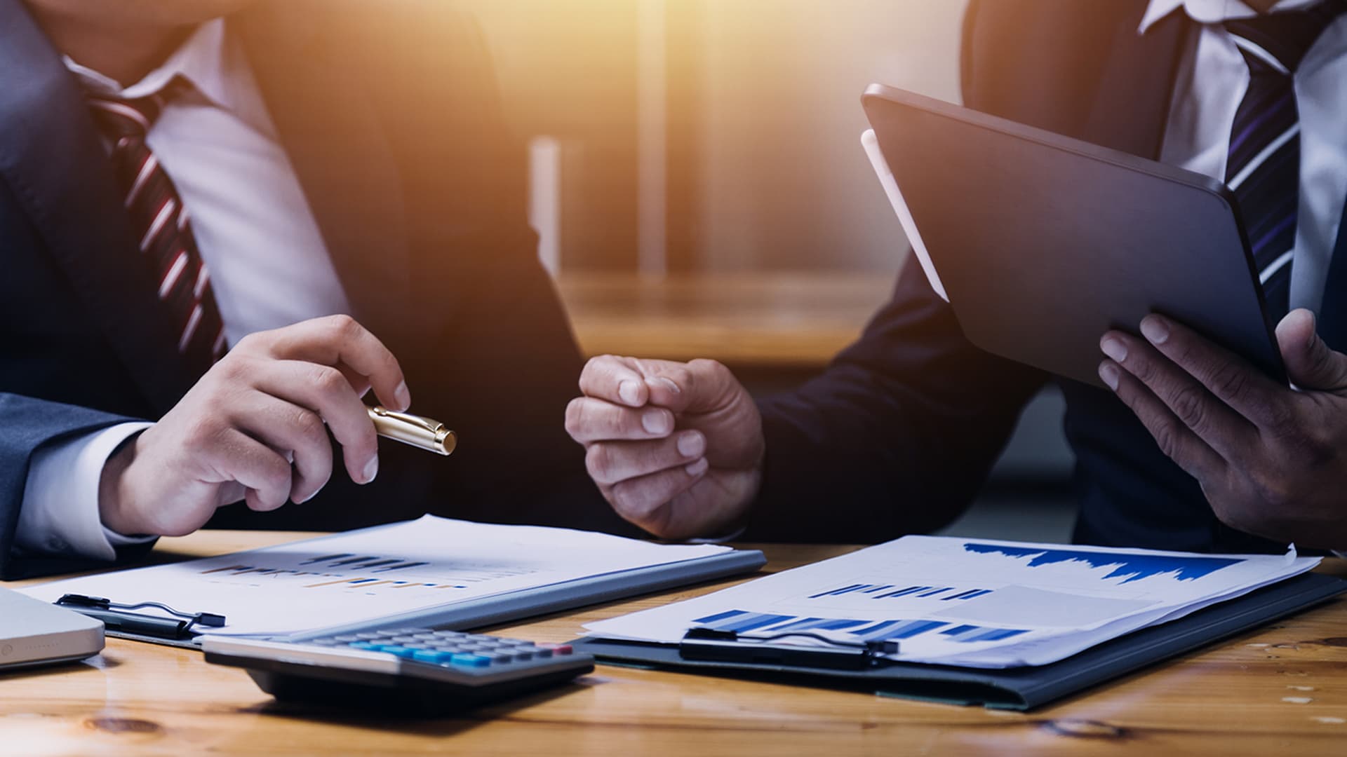 GP equity depicted by two individuals going over financial data